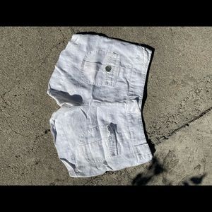 White linen shorts, pearl buttons